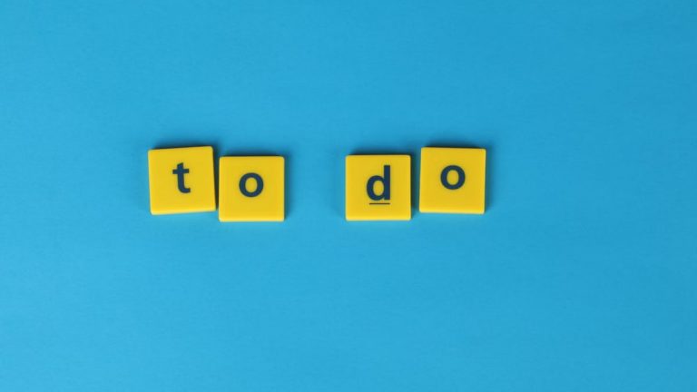 Yellow letter tiles spelling 'to do' against a vibrant blue background for organizational themes.